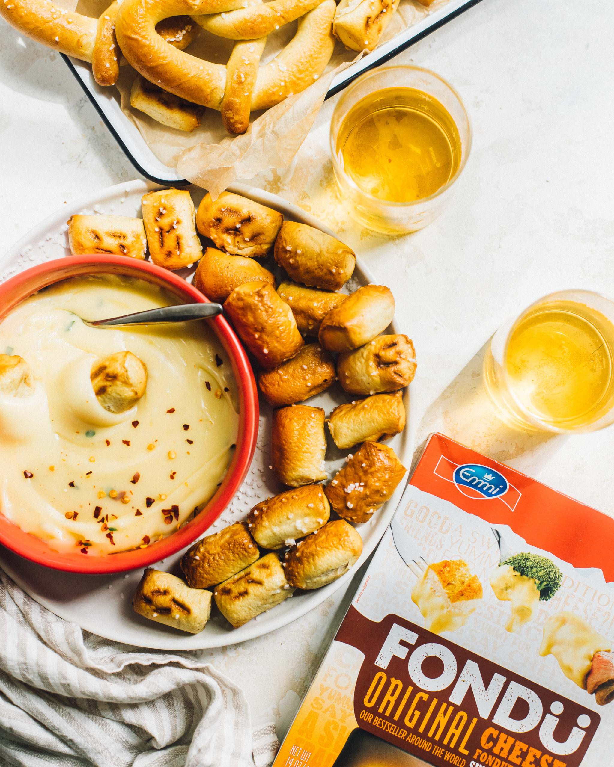 Fondue with pretzels and beer. Emmi Roth